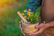 © yanadjan - A man collects medicinal herbs in a field. Selective focus.