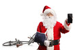 © Ljupco Smokovski - Santa Claus with a bicycle and arm injury holding a smartphone
