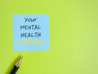 © Frederica Aban - Your mental health matters text written on note paper with copy space background.