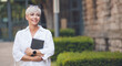 © Alen-D - Smiling adult woman posing and holding book. Cheerful pretty adult woman with a book