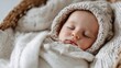 © Anastasiia - A baby sleeping peacefully, wrapped in a cozy knitted blanket and hat. Concept Cozy baby portrait, Knitted blanket textures, Soft lighting, Sleeping infant, Warm hat details