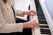 © Nikolay - Female hands playing the piano