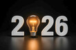 © Ольга Клецкова - New year 2026 with glowing light bulb as zero symbolizing energy, power supply and electric industry on black background