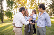 © Lupe Rodriguez/Stocksy - Happy Spanish family together in garden of big house