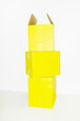 © Colour Laboratory/Stocksy - Pile of yellow empty mockup cardboard boxes with space for text/design