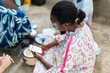 © Alvaro Lavin/Stocksy - Senegalese woman using mobile phone in a village in Africa