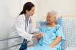 © amazing studio - Asian doctor checking and treat elderly woman patient health in hospital.