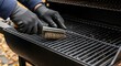 © velikiyzayats - Close-up of hands in black gloves cleaning a dirty barbecue grill with a wire brush outdoors