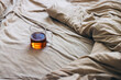 © OchreOchre/Stocksy - Cozy Cup of Hot Tea Resting on Comfortable Light Beige Bedding