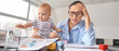 © Pixel-Shot - Stressed mother with her baby working in office