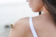 © Ivan Andrianov/Stocksy - Butterfly Perched on Shoulder of Woman Outdoors Near Water