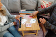 © Rob and Julia Campbell/Stocksy - Two adults playing a card game on a cozy wooden table at home