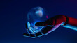 © Marcos Osorio/Stocksy - Robot hand holds glowing sphere in futuristic AI concept