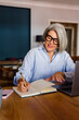 © mahalo studio/Stocksy - Woman turning notebook page