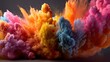 © irawan - Vibrant clouds of multicolored powder explode across a dark background.