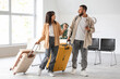 © Pixel-Shot - Young couple with suitcases waiting for their flight in airport lounge