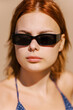 © Alexey Kuzma/Stocksy - Woman in Sunglasses Enjoying a Sunny Day at the Beach