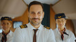 © Videophilia - Professional airline pilot and cabin crew members standing in the airplane, proudly representing excellent service, safety, and teamwork for air travel