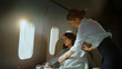 © Videophilia - Flight attendant providing comfort by covering a sleeping female passenger with a blanket during a luxurious private jet flight, emphasizing premium travel service and privacy