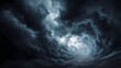 © Bussakon - A dark swirling vortex of stormy clouds creating a dramatic and ominous tunnel effect in the sky