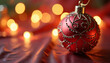 © Anet_foto - Red Christmas ornament with gold beading on satin surface, glowing festive elegance