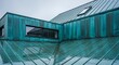 © Murs - Glistening Verdigris Architectural Detail of a Wet Patinated Copper Roof and Facade.