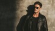 © Crocodilchik - Stylish model in black leather coat and sunglasses posing confidently