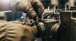 © Dmitry - Mechanic in protective glove adjusting a part on an industrial machine. Close up of skilled worker performing maintenance on factory equipment.