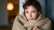 © forenna - A person wrapping themselves in a blanket near an indoor heater, symbolizing coziness, relaxation, and home well-being on a cold day. cinematic color correction, natural uneven lighting yet gentle