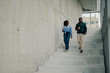 © Zamrznuti tonovi - Colleagues walking down stairs, discussing during coffee break