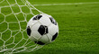 © fatema202 - Soccer ball in a net on a green grass field