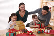 © New Africa - Happy family with Christmas gifts at home