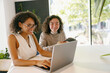 © Yaroslav Astakhov - mentors guiding with enthusiasm, partners collaborating happily on laptop during teaching moment