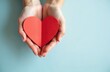 © miss irine - Woman hands hold red heart shape against blue background. Handmade heart shape symbolizes love care compassion. Charity donation concept. Perfect photo for healthcare social projects.