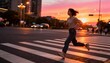 © Evarelle - Young Asian woman running across a city crosswalk at sunset. Active female exercising in an urban environment during golden hour. Healthy lifestyle and fitness concept