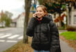 © tan4ikk - Happy Girl Talking On The Phone Against A Blurred Street Background