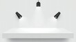 © Photographybd60 - Empty white shelf illuminated by spotlights against a plain wall