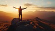 © Crafted - A man stands with arms outstretched on a mountain peak at sunset, silhouetted against the sky with mountain ranges in the background.