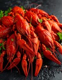 A close-up showcases a pile of bright red, cooked crustaceans arranged on a plate with fresh green herbs. The dark background adds contrast