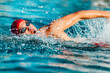 © Maridav - Swimming man. Swim competition swimmer athlete doing crawl stroke in swimming pool. Sports man male swimmer with goggles and cap breathing racing in indoor stadium. Speed exercise workout.