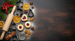 © AucArtStudio - Gingerbread cookies on tray with jam filled biscuits cinnamon and dried orange create festive christmas and new year baking scene full of warmth and joyful holiday spirit