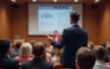 © cui - Blurred speaker giving speech at business seminar in auditorium. Background of presenter in hall meeting during public lecture. Defocused businessman in conference hall with bokeh. High quality