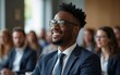 © cui - Portrait happy smiling African American ethnic male man guy businessman student in glasses formal suit listening business training class seminar presentation learning blurred crowd indoor meeting room