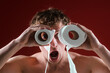 © Volodymyr - Restroom concept. A funny man uses toilet paper rolls as goggles. Humorous portrait with a shocked crazy expression with toilet paper. Comical lifestyle scene with toilet paper.
