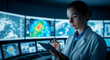 © ABAStock - Focused woman analyzes weather data on a digital tablet in a high-tech control room