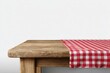 © Moh - Wooden table with red and white checkered tablecloth against a white background