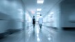 © CStock - Blurry figures walking in a hospital corridor, emphasizing the busy atmosphere of healthcare facilities.