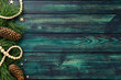 © photoguns - Rustic teal wooden background with pine branches and pinecones on right side, natural festive composition for Christmas or winter design.