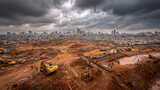 Urban construction site with heavy machinery working on excavated dirt land under dramatic cloudy sky with high-rise city skyline in the background and people walking in dusty open area
