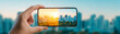 © Yuparet - Hand holding smartphone city skyline before and after photo effect vibrant sunlight urban landscape technology creative editing modern cityscape outdoor blue sky